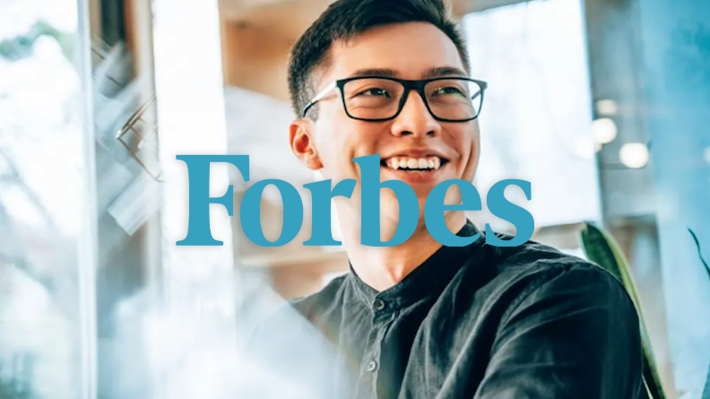 Man wearing glasses with the Forbes logo on top.