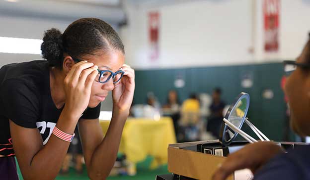 Get Help Image of a girl looking into a mirror wearing glasses