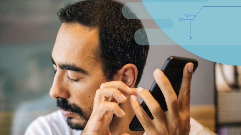 A man with low vision operating a smartphone. 